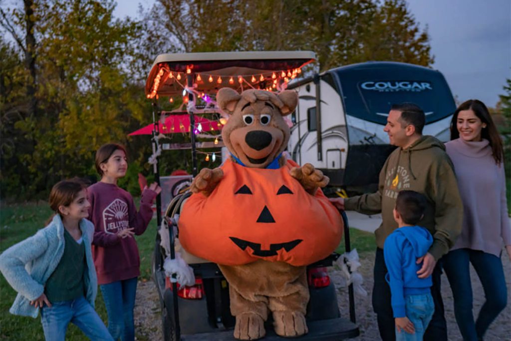 Halloween Spooktacular Family Fun | Jellystone Park™ South Haven Family enjoying Halloween Spooktacular with the Jellystone Park™ mascot at South Haven