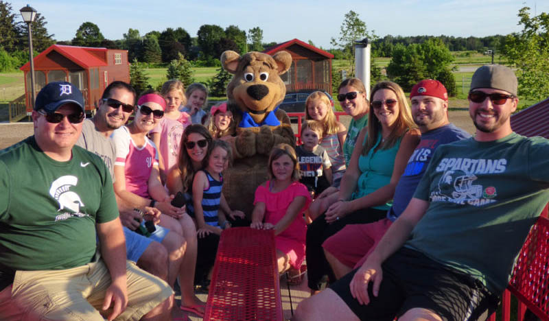 Families taking a wagon ride with Boo Boo™ at Jellystone Park™ South Haven
